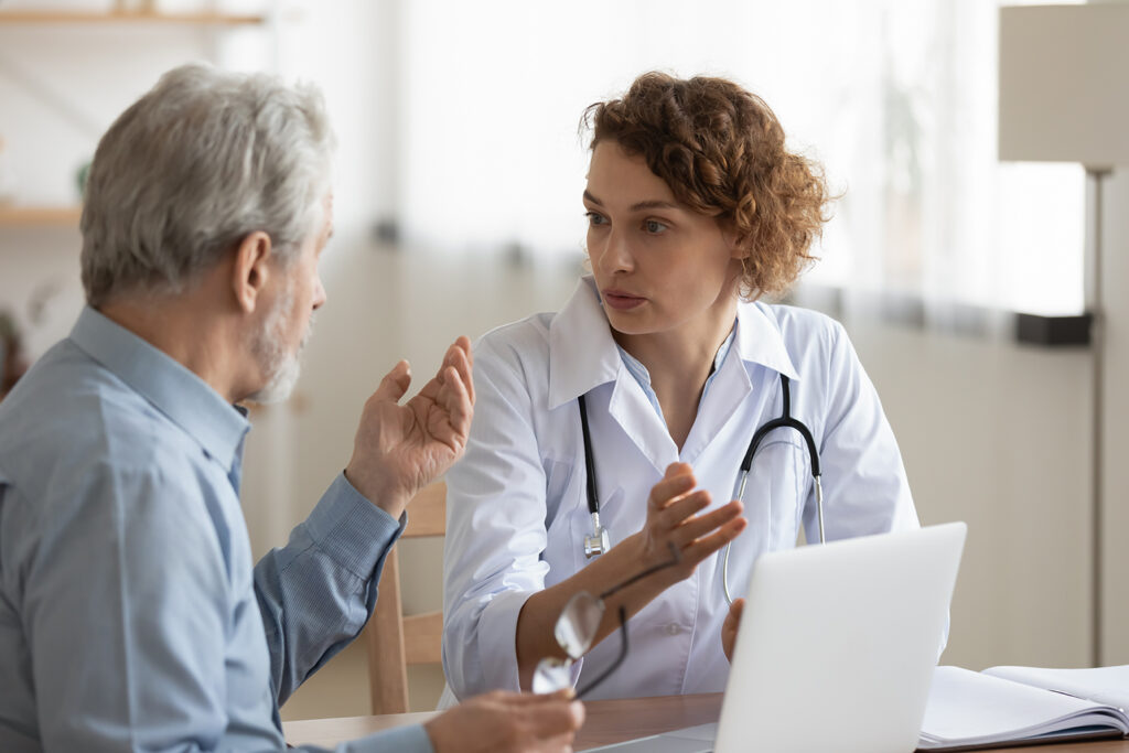 a doctor talking to a stoma patient post surgery